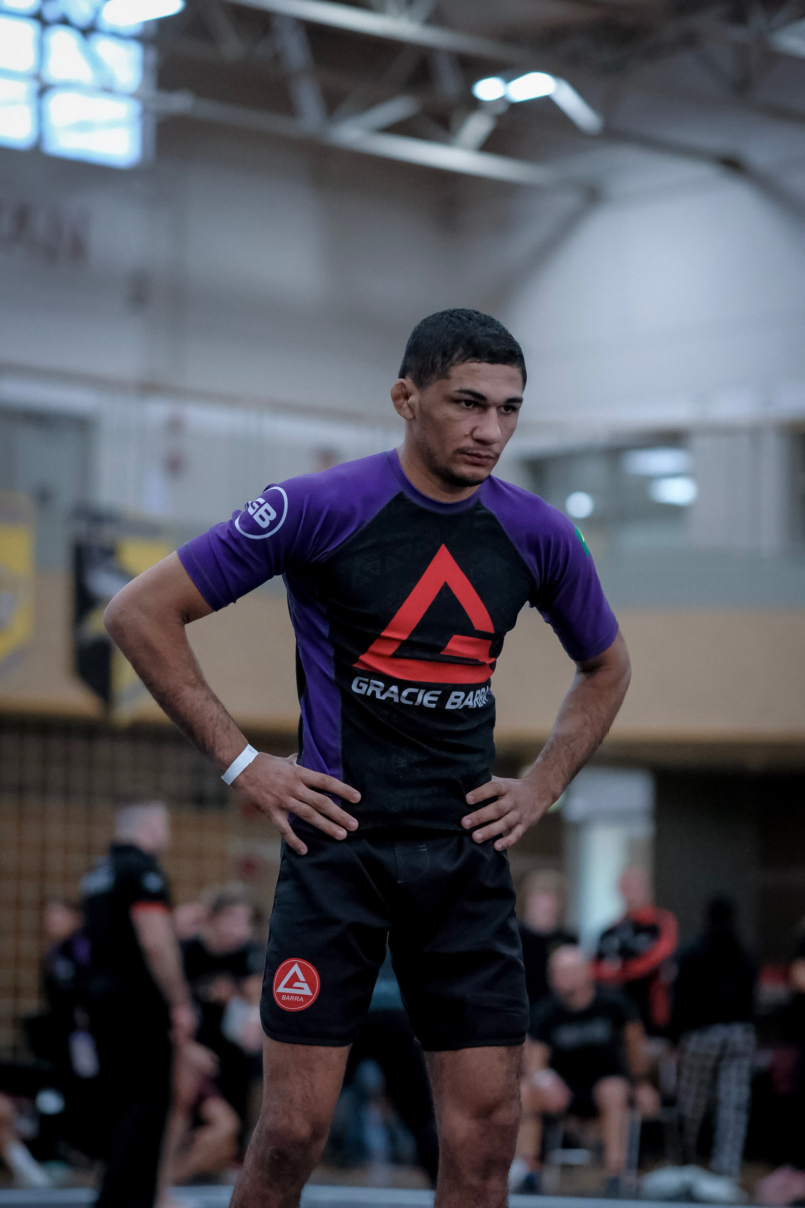 Wellington Andrade standing on the mat in a Gracie Barra rashguard.